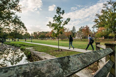 Students walking by the Campus River in Dunn Meadow on the IU Bloomington campus.